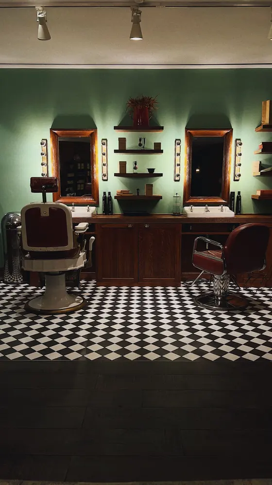 Vintage leather barber chairs and a black-and-white checkered floor
