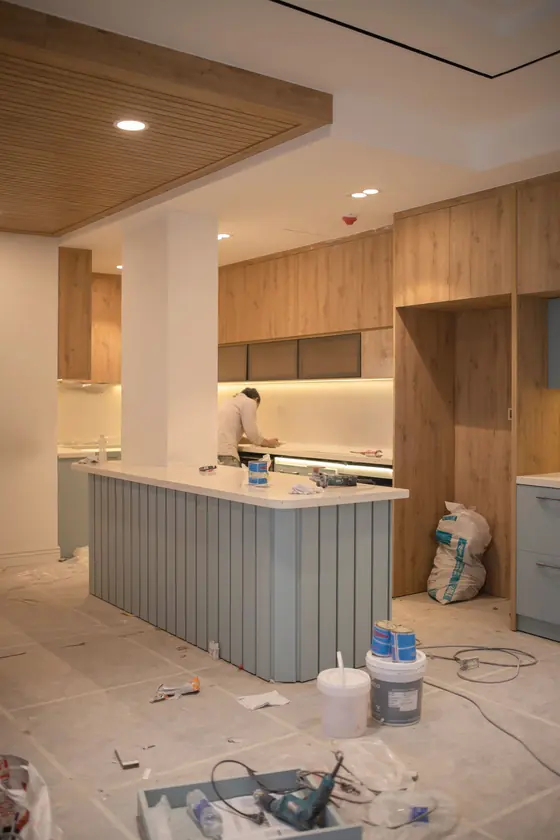 Kitchen mid-renovation with new wood cabinets installed