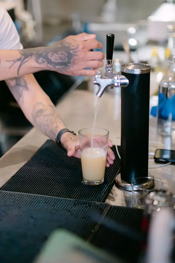 Bartender pouring a craft beer from the tap